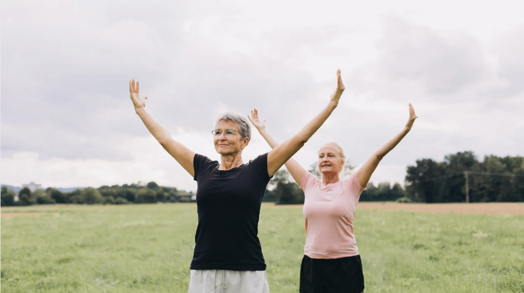 Active older adults practicing movement outdoors, symbolizing healthy aging and vitality.